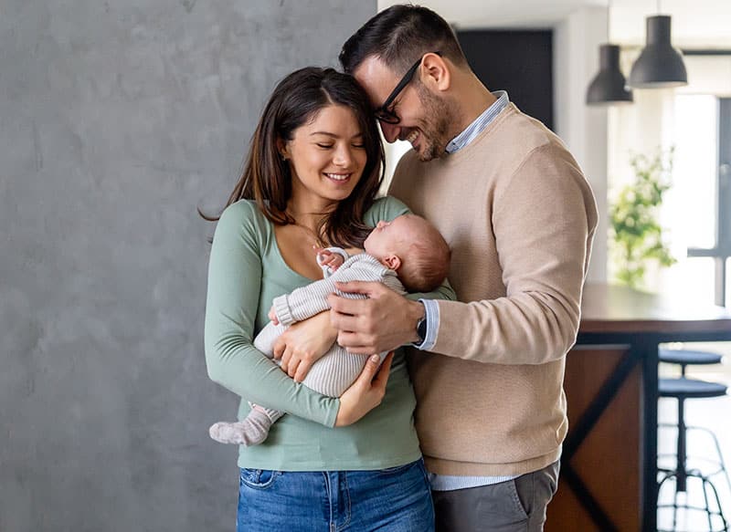 intended parents together with new baby