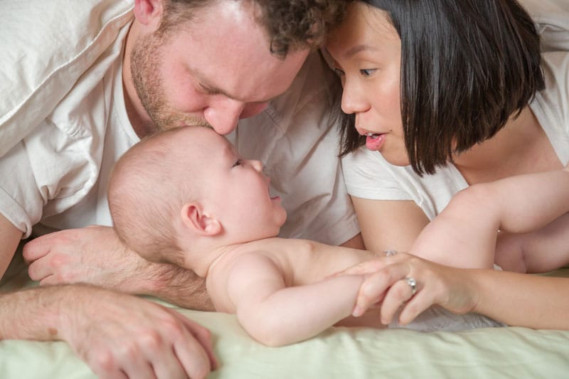 mixed race chinese and caucasian baby boy laying