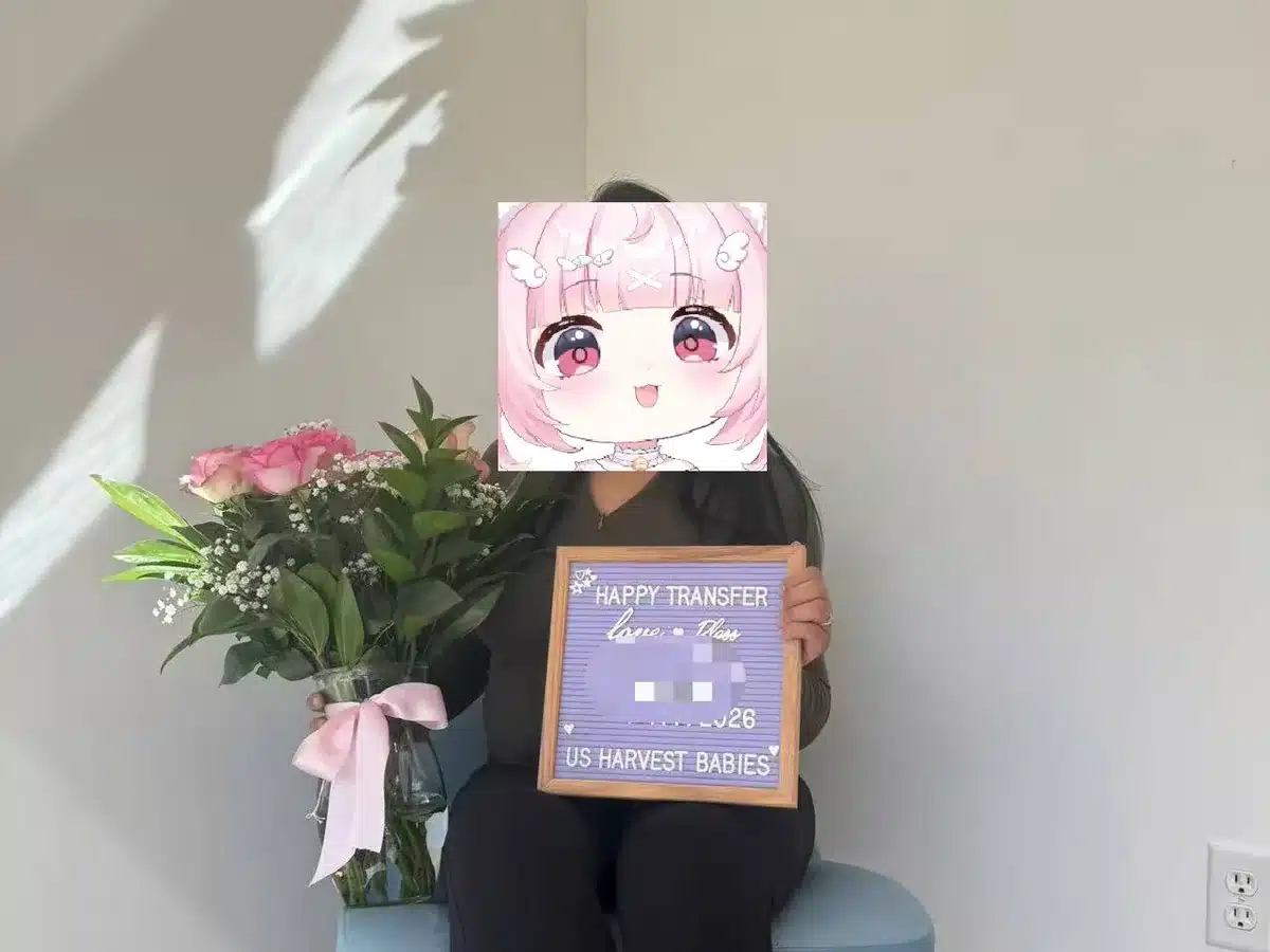 A surrogate celebrating her transfer milestone with flowers